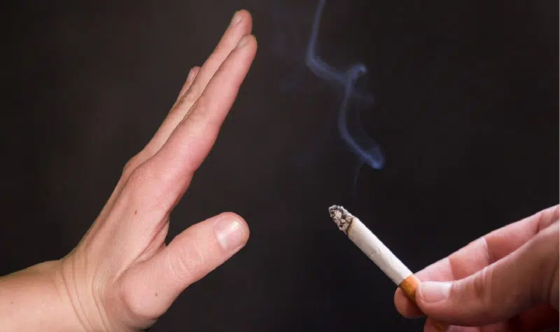 hand signaling no to an offer of a cigarette