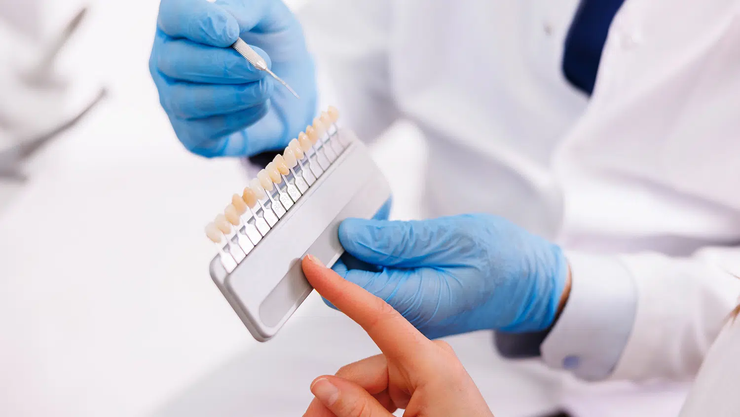Dental patient looking at sample veneers